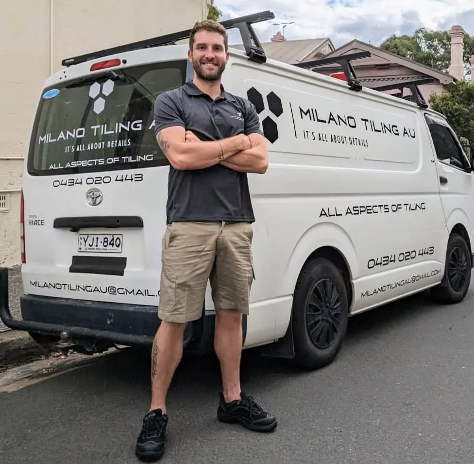 Davide Torriglia, founder of Milano Tiling & Waterproofing, beside his work van in Sydney